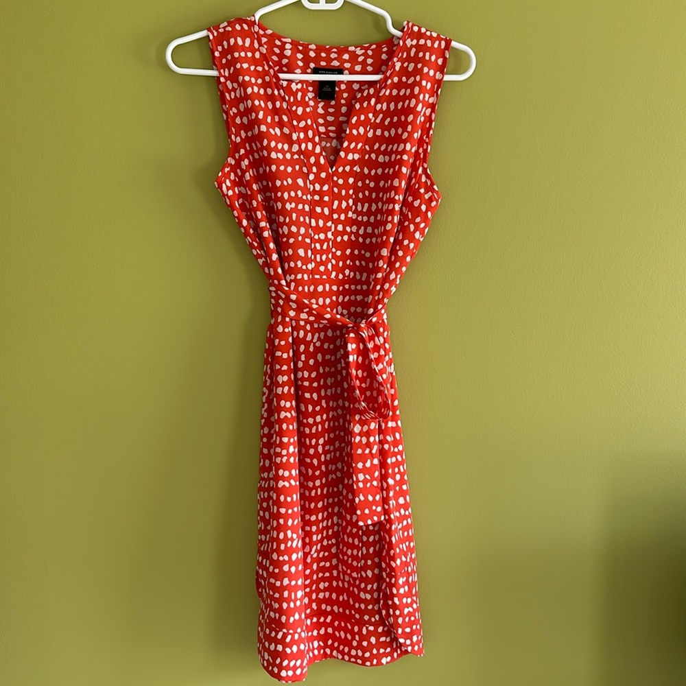 Beautiful light polyester orange/cream dress. Matching tie belt and side slits.